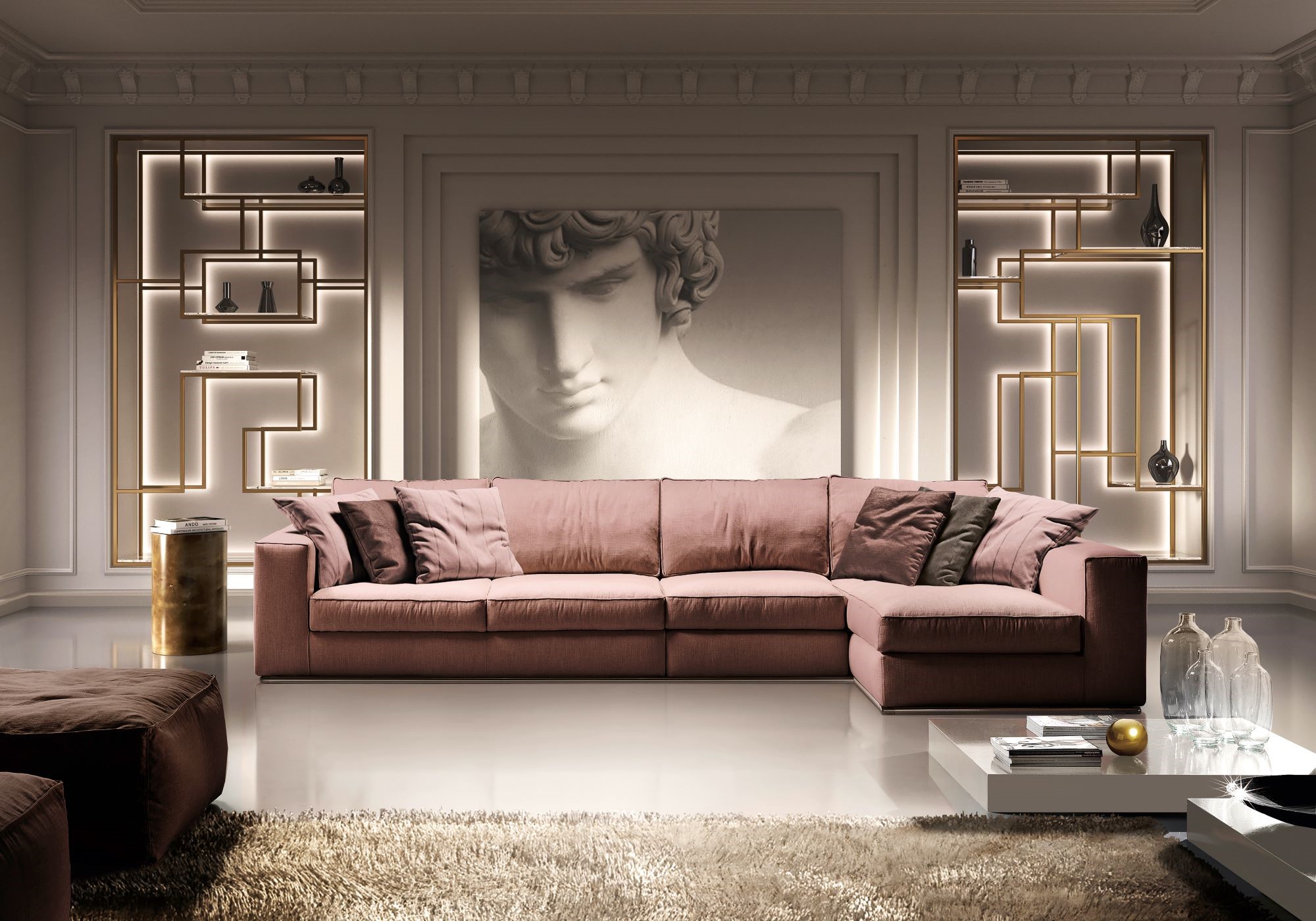 Sectionary sofa with chaise longue upholstered with pink fabric perfect for contemporary house. The living room is designed with wooden boiserie and gold painted metal bookshelves